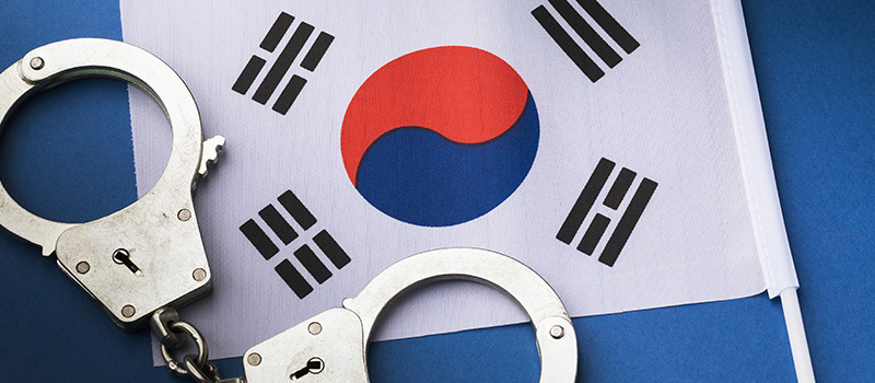 Korea-Flag-Arrest-Handcuffs